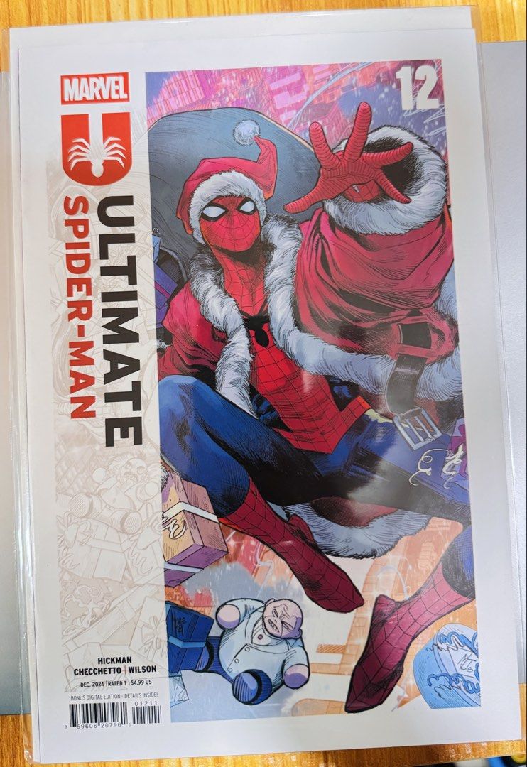 Ultimate Spider-Man #12 Marvel Comic Book Holiday Cover (Category: Comics & Manga) located in Malabon City. Submitted by wilbert.te (Listing ID 1470899730, Image 1). Description: - Title: Ultimate Spider-Man #12 (Marvel, Dec 2024) - Cover: Christmas variant featuring Spider-Man in a Santa hat and red coat with wrapped gifts and a Kingpin toy - Creators: Written by Jonathan Hickman, art by Marco Checchetto and Matthew Wilson - Condition: Bagged an