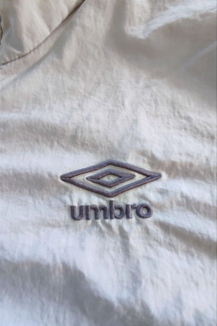 Umbro Beige Anorak Windbreaker Pullover Jacket (Category: Coats, Jackets and Outerwear) located in Dipolog. Submitted by mikkoatill43159 (Listing ID 1470789342, Image 3). Description: - Brand: Umbro - Style: Pullover anorak windbreaker / Half-zip placket with branded pull tab - Color: Neutral beige / Earth tone - Size: 24x26.5(boxy) - Can fit Medium to Large - Features: Stand collar, large front pouch pocket, embroidered diamond logo on chest, an