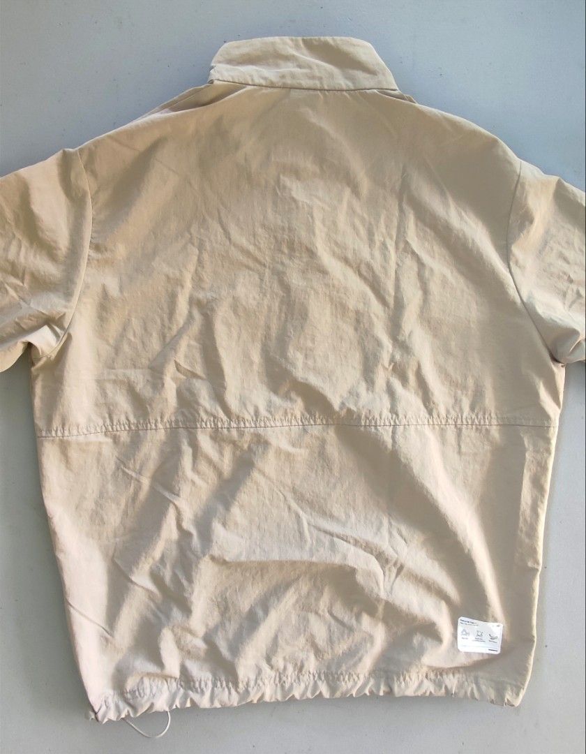 Umbro Beige Anorak Windbreaker Pullover Jacket (Category: Coats, Jackets and Outerwear) located in Dipolog. Submitted by mikkoatill43159 (Listing ID 1470789342, Image 2). Description: - Brand: Umbro - Style: Pullover anorak windbreaker / Half-zip placket with branded pull tab - Color: Neutral beige / Earth tone - Size: 24x26.5(boxy) - Can fit Medium to Large - Features: Stand collar, large front pouch pocket, embroidered diamond logo on chest, an