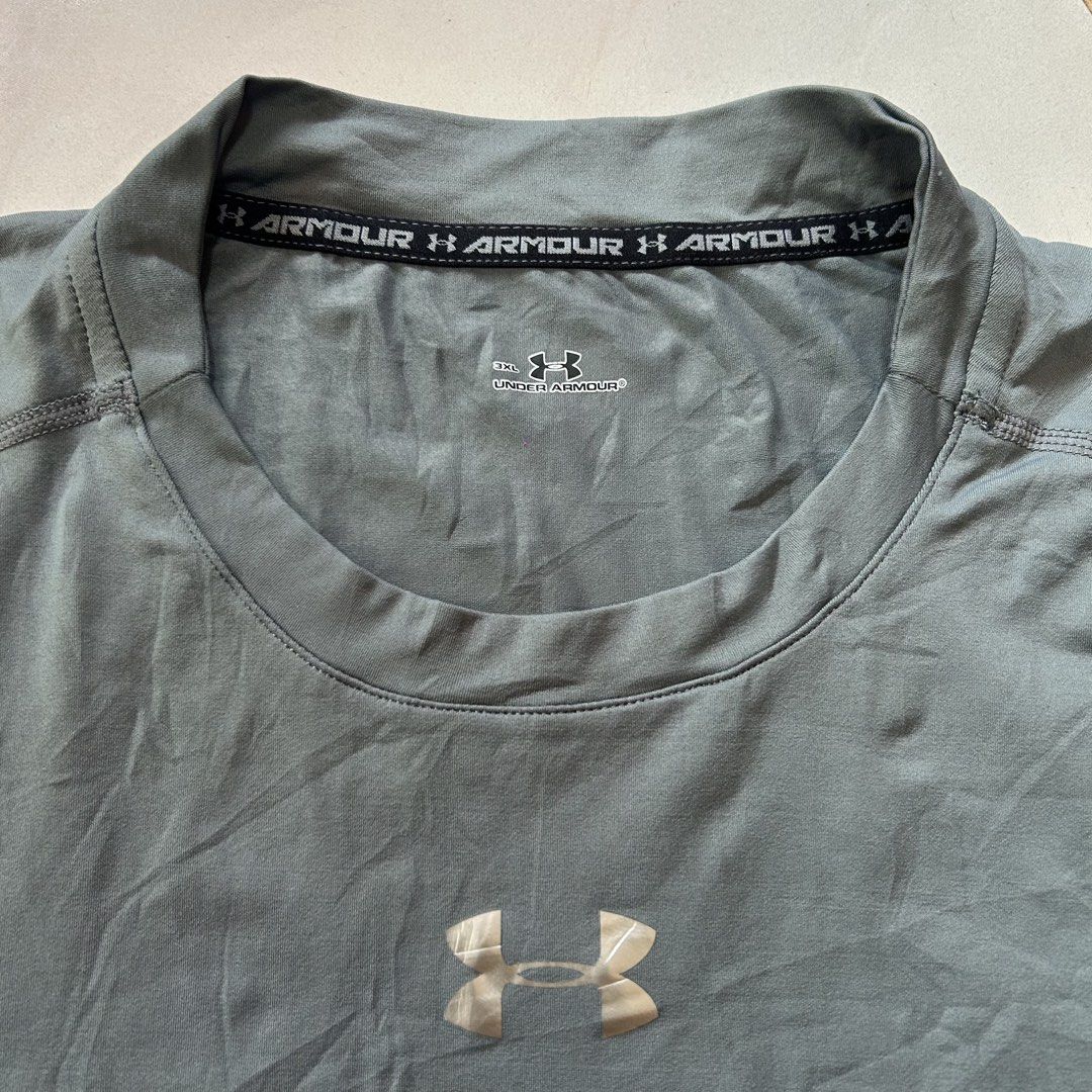 Under Armour Athletic T-Shirt 🥵 (Category: Activewear) located in Jinoba-an. Submitted by eegiboy (Listing ID 1470786770, Image 3). Description: - Brand: Under Armour - Size: 3xl best fit medium to large - Color: Grey, neon green, and black - Material: Nylon and polyurethane blend - Design: Short sleeves, crew neck, printed logo on chest and back collar - Origin: Made in China - Condition: Excellent Wts: Ua 🔥 Best fit Medium to large 🥵 Dimes:1