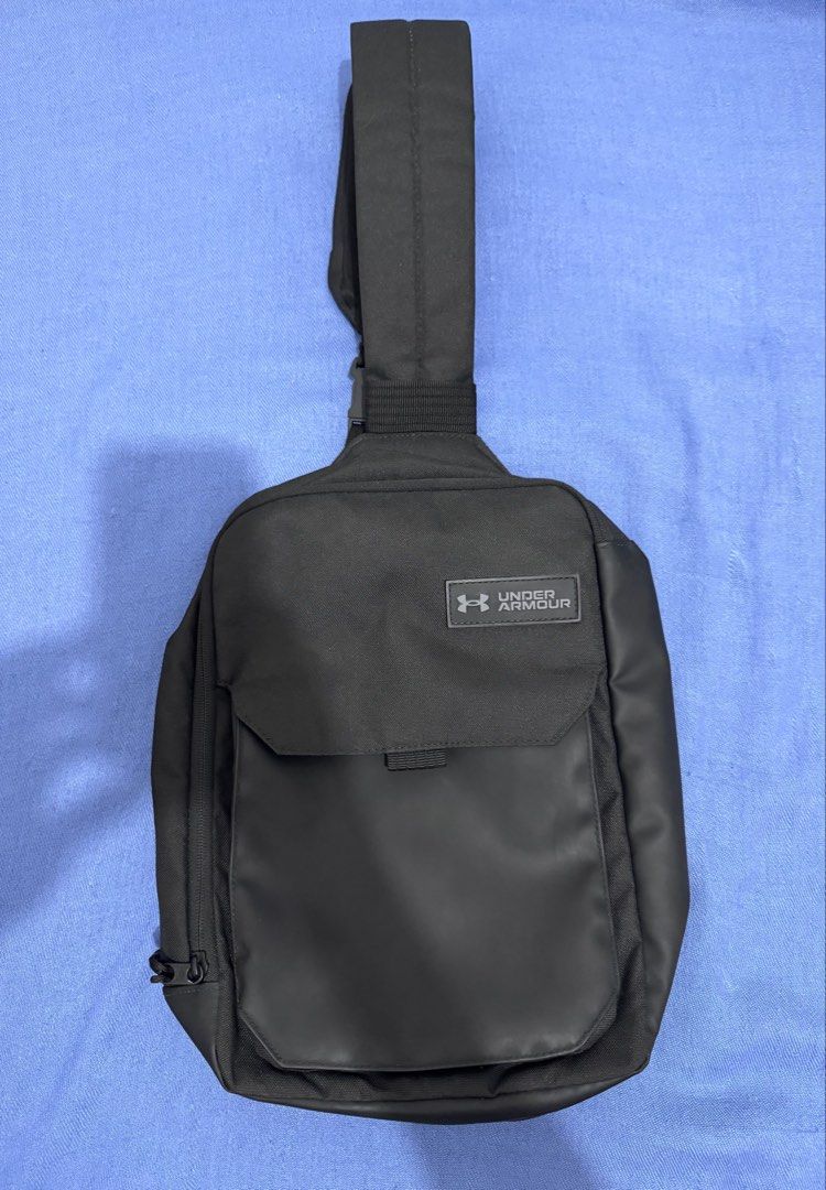 Under Armour Black Sling Bag Crossbody Backpack (Category: Sling Bags) located in Manila. Submitted by kazoo1490 (Listing ID 1470782570, Image 3). Description: - Brand: Under Armour - Color: Classic Black with sleek front patch logo - Material: Highly durable fabric construction - Comfort: Padded mesh back panel for maximum airflow - Storage: Roomy main compartment with smooth zipper and dedicated internal sleeve for a laptop or tablet - Fit: Sin