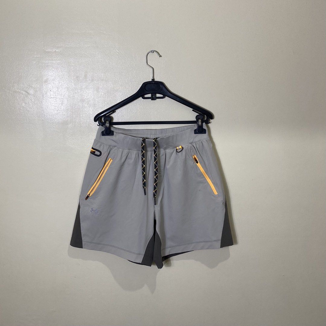 Under Armour Grey Orange Athletic Training Shorts Medium M (Category: Shorts) located in Cebu City. Submitted by theloose.thread (Listing ID 1470918055, Image 1). Description: - Brand: Under Armour - Condition: Excellent / Pre-loved - Size: MD - Color: Grey and dark charcoal - Pockets: Orange zipper pockets on front and back - Waistband: Elastic with adjustable patterned drawstring - Material: Lightweight and breathable - Ideal for: Workouts, gym