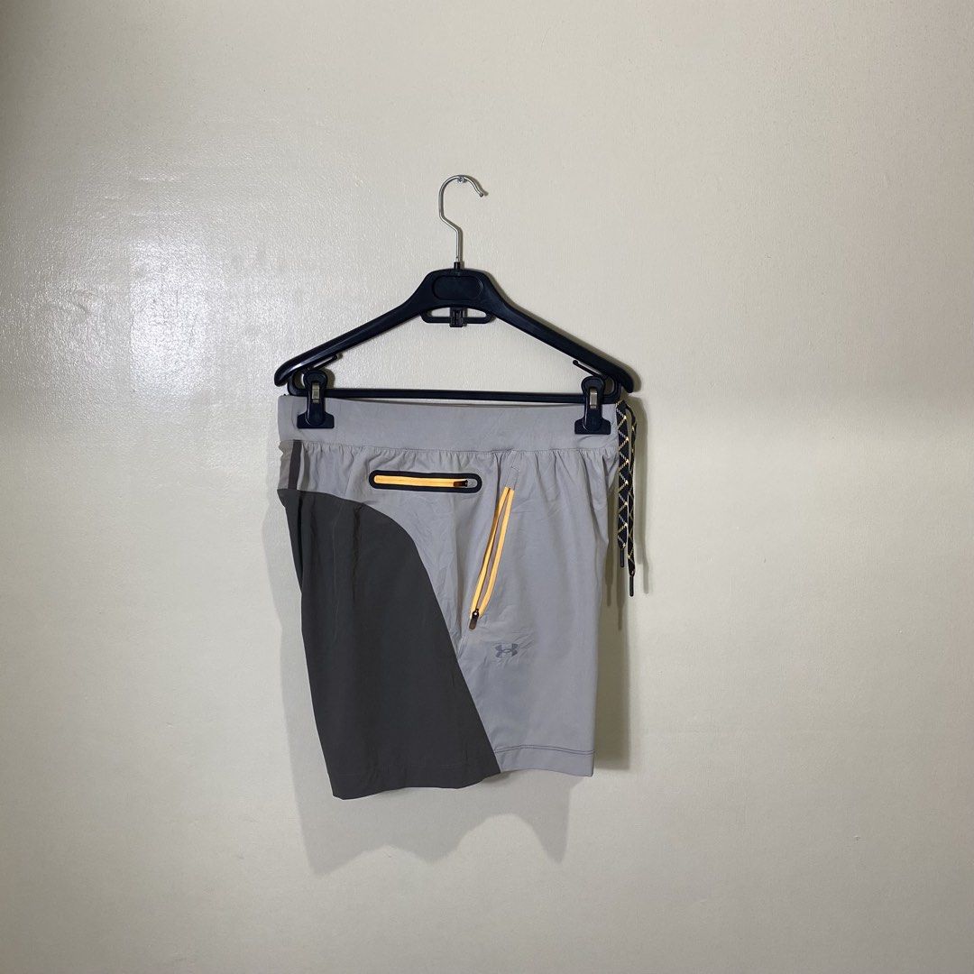 Under Armour Grey Orange Athletic Training Shorts Medium M (Category: Shorts) located in Cebu City. Submitted by theloose.thread (Listing ID 1470918055, Image 2). Description: - Brand: Under Armour - Condition: Excellent / Pre-loved - Size: MD - Color: Grey and dark charcoal - Pockets: Orange zipper pockets on front and back - Waistband: Elastic with adjustable patterned drawstring - Material: Lightweight and breathable - Ideal for: Workouts, gym