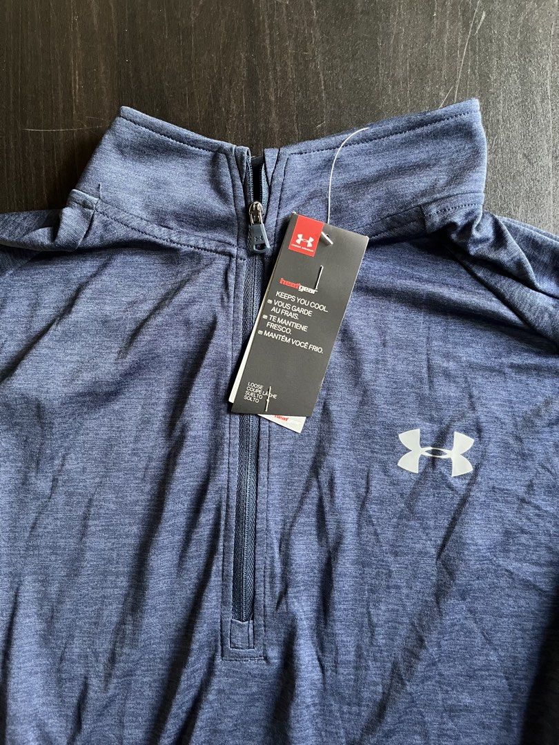 Under Armour HeatGear 1/2 Zip Pullover Blue (Category: Activewear) located in Manila. Submitted by sunshineapril (Listing ID 1470808171, Image 3). Description: - Brand: Under Armour - Condition: Brand New - Color/Fabric: Blue heathered fabric - Technology: HeatGear to keep you cool during workouts - Fit & Style: Loose fit, long sleeves, high collar, and convenient zip garage - Ideal For: Running, gym sessions, and active workouts.