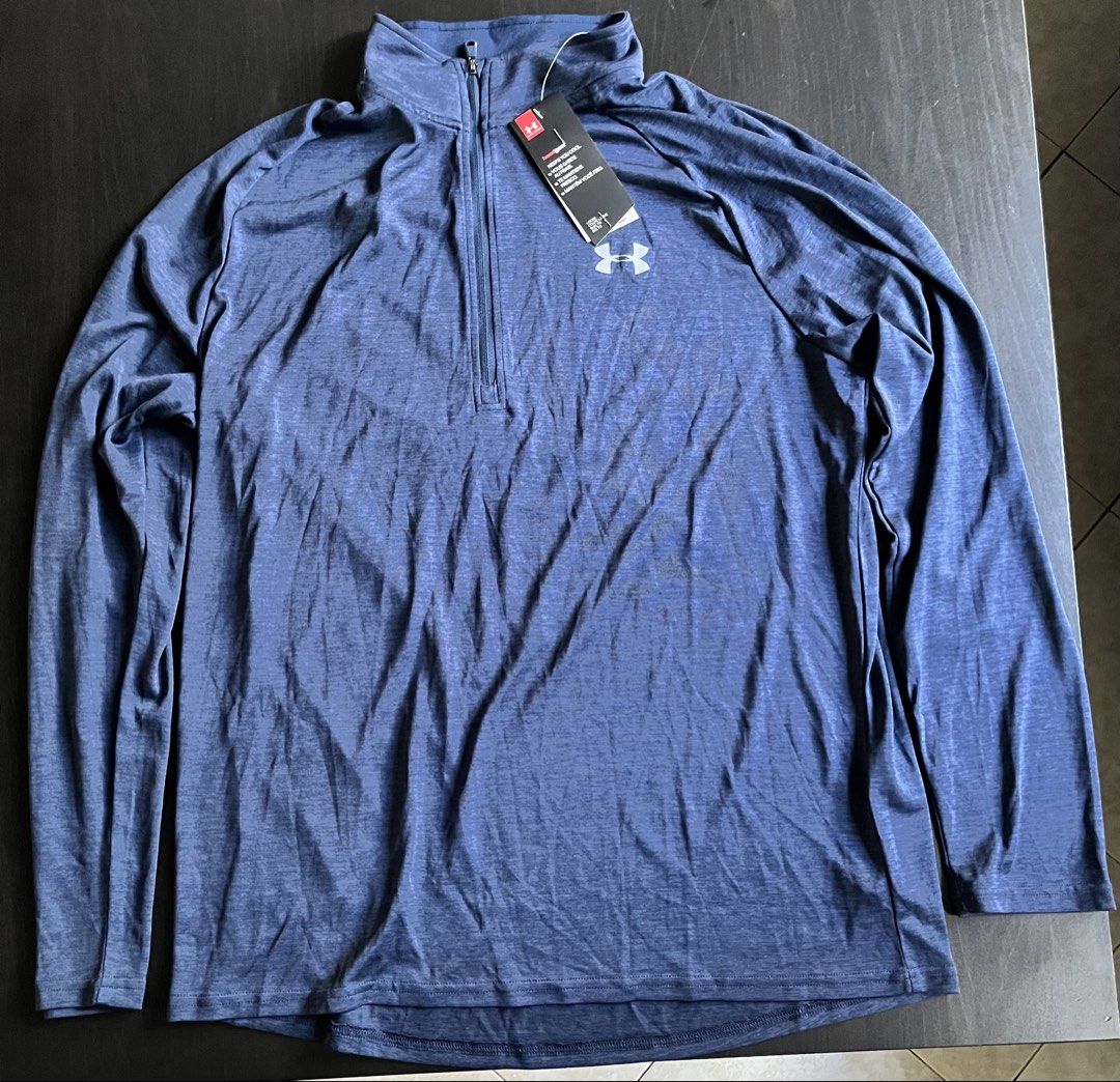 Under Armour HeatGear 1/2 Zip Pullover Blue (Category: Activewear) located in Manila. Submitted by sunshineapril (Listing ID 1470808171, Image 1). Description: - Brand: Under Armour - Condition: Brand New - Color/Fabric: Blue heathered fabric - Technology: HeatGear to keep you cool during workouts - Fit & Style: Loose fit, long sleeves, high collar, and convenient zip garage - Ideal For: Running, gym sessions, and active workouts.