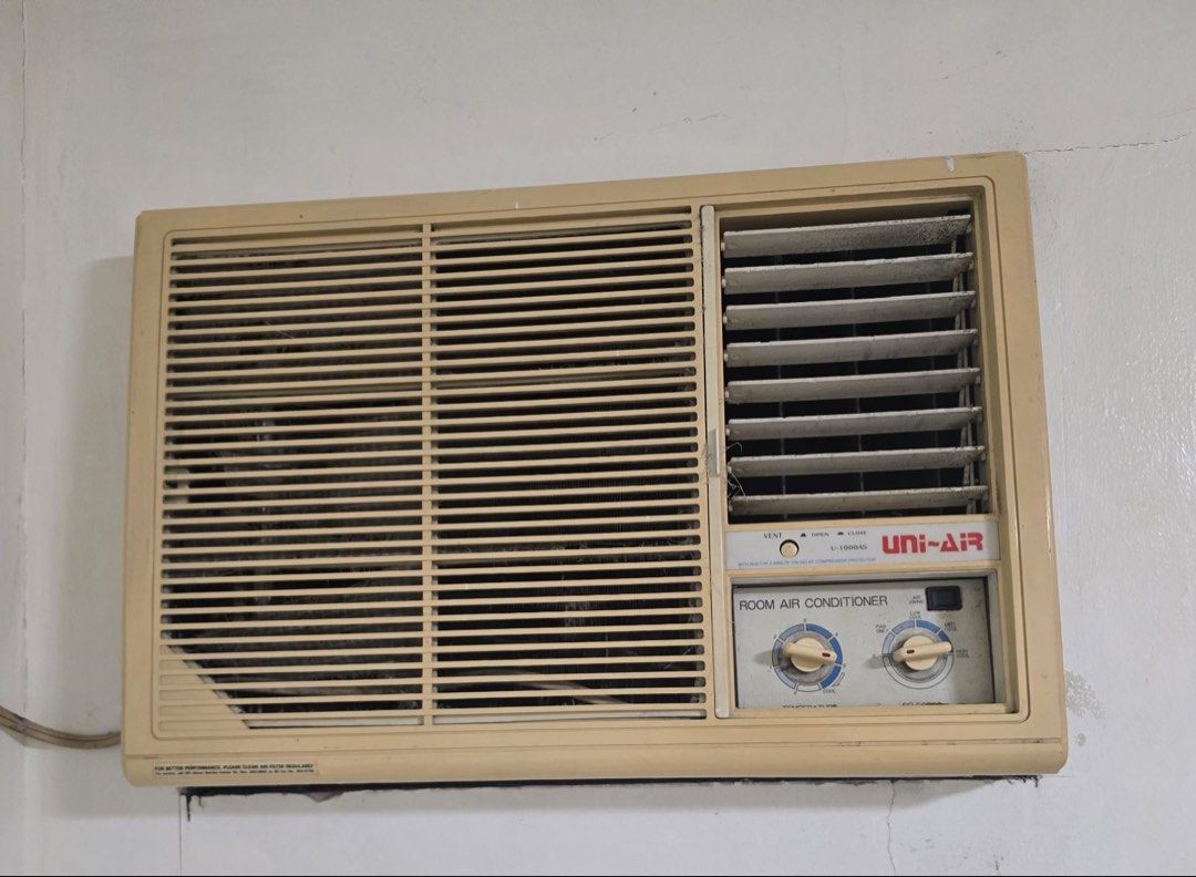 Uni-Air Room Air Conditioner U-1000AS (Category: Air Conditioning and Heating) located in Paranaque City. Submitted by joanrose17 (Listing ID 1470746536, Image 1). Description: - Brand/Model: Uni-Air Room Air Conditioner, Model U-1000AS - Condition: Powers up and runs well; features vintage beige casing with expected yellowing from aging and heavy dust on the front grill that needs cleaning - Controls: Dual rotary dials for temperature and fan sp