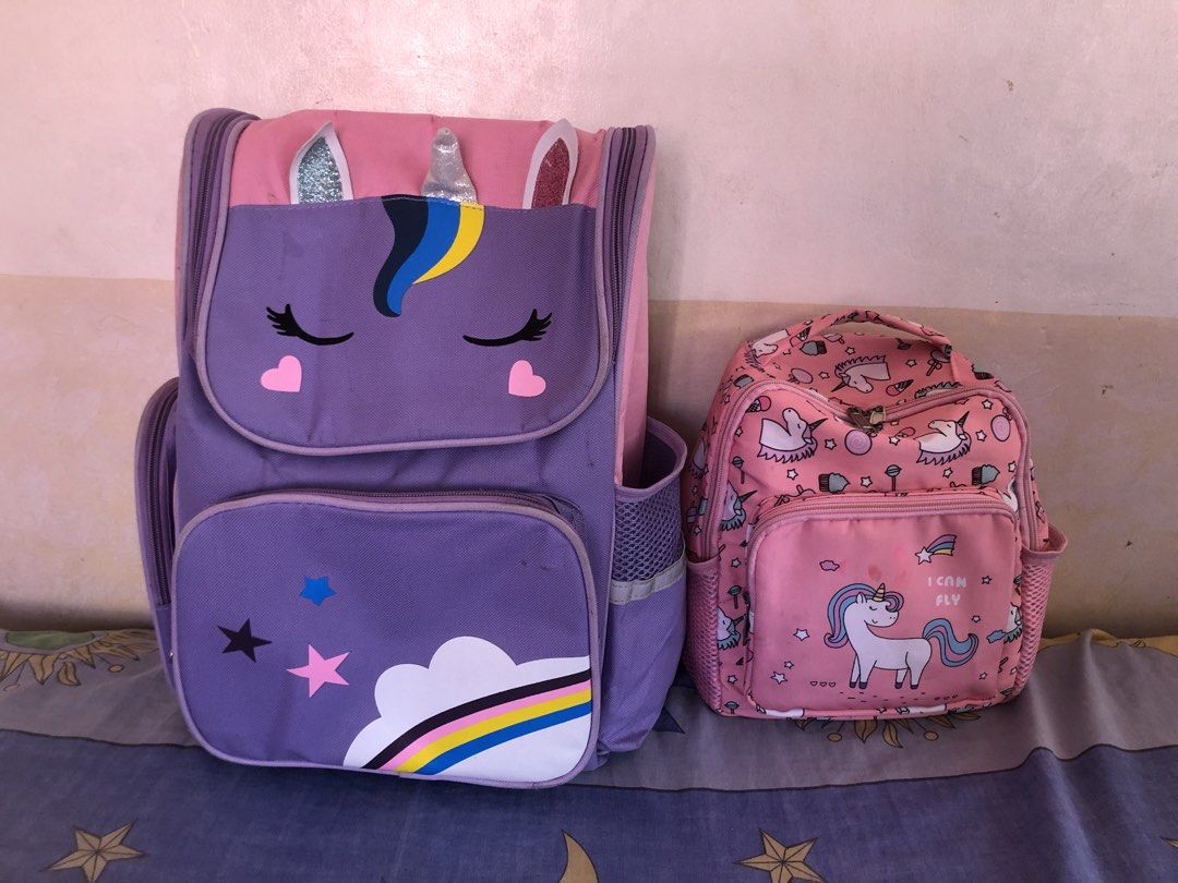 Unicorn Backpacks 2 for 180 (Category: Babies & Kids Fashion) located in Cavite. Submitted by ai__chang (Listing ID 1470750233, Image 2). Description: - Matching 2-piece unicorn bag set in lovely purple and pink - Large backpack features a sleeping unicorn face, 3D horn and ears, and rainbow cloud graphics - Smaller bag comes with an allover unicorn pattern and front zip pocket - Both bags include handy mesh side pockets for water bottles or smal
