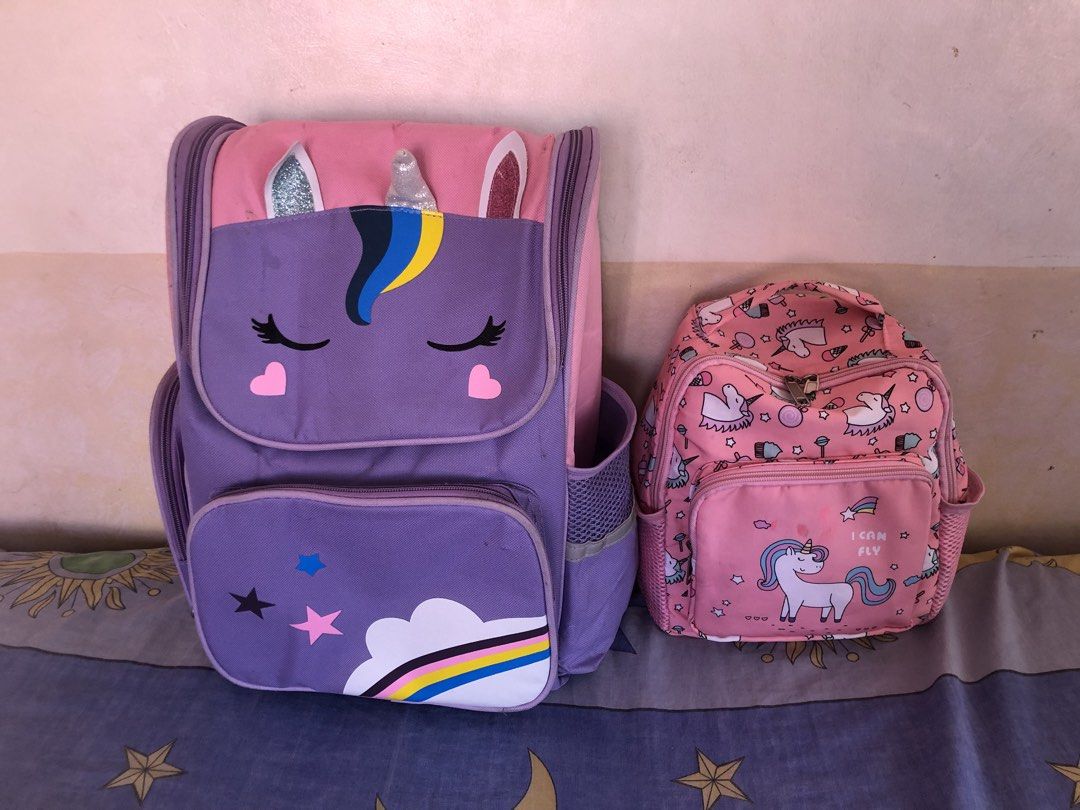 Unicorn Backpacks 2 for 180 (Category: Babies & Kids Fashion) located in Cavite. Submitted by ai__chang (Listing ID 1470750233, Image 3). Description: - Matching 2-piece unicorn bag set in lovely purple and pink - Large backpack features a sleeping unicorn face, 3D horn and ears, and rainbow cloud graphics - Smaller bag comes with an allover unicorn pattern and front zip pocket - Both bags include handy mesh side pockets for water bottles or smal