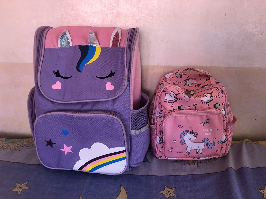 Unicorn Backpacks 2 for 180 (Category: Babies & Kids Fashion) located in Cavite. Submitted by ai__chang (Listing ID 1470750233, Image 1). Description: - Matching 2-piece unicorn bag set in lovely purple and pink - Large backpack features a sleeping unicorn face, 3D horn and ears, and rainbow cloud graphics - Smaller bag comes with an allover unicorn pattern and front zip pocket - Both bags include handy mesh side pockets for water bottles or smal