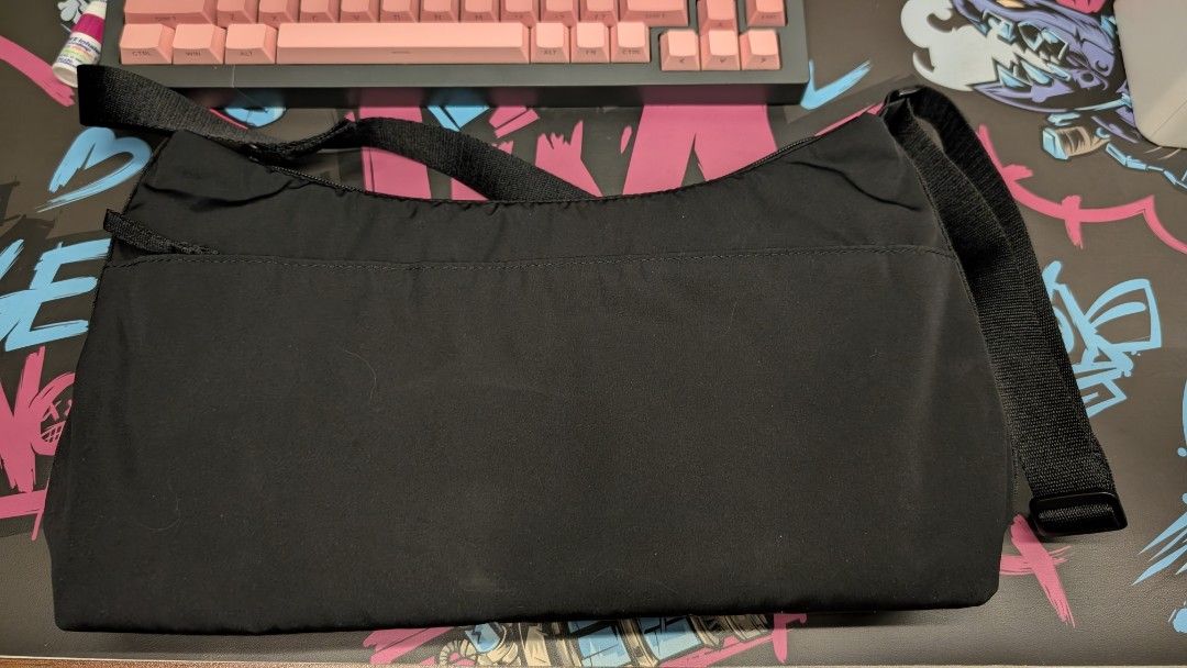Uniqlo Black Nylon Round Mini Shoulder Bag (Category: Shoulder Bags) located in Pateros City. Submitted by glims (Listing ID 1470816727, Image 1). Description: - Brand: Uniqlo - Color: Black - Material: Durable and lightweight nylon - Versatile: Adjustable strap for shoulder or cross-body carry - Storage: Roomy main compartment with secure zipper and internal pockets - Condition: Clean inside and out, perfect everyday basic.