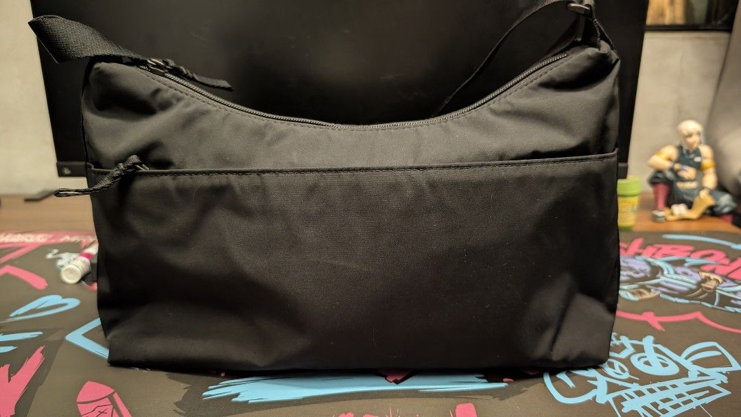 Uniqlo Black Nylon Round Mini Shoulder Bag (Category: Shoulder Bags) located in Pateros City. Submitted by glims (Listing ID 1470816727, Image 3). Description: - Brand: Uniqlo - Color: Black - Material: Durable and lightweight nylon - Versatile: Adjustable strap for shoulder or cross-body carry - Storage: Roomy main compartment with secure zipper and internal pockets - Condition: Clean inside and out, perfect everyday basic.