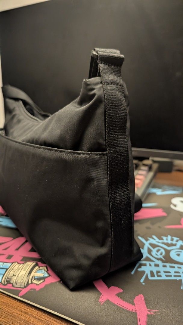 Uniqlo Black Nylon Round Mini Shoulder Bag (Category: Shoulder Bags) located in Pateros City. Submitted by glims (Listing ID 1470816727, Image 2). Description: - Brand: Uniqlo - Color: Black - Material: Durable and lightweight nylon - Versatile: Adjustable strap for shoulder or cross-body carry - Storage: Roomy main compartment with secure zipper and internal pockets - Condition: Clean inside and out, perfect everyday basic.