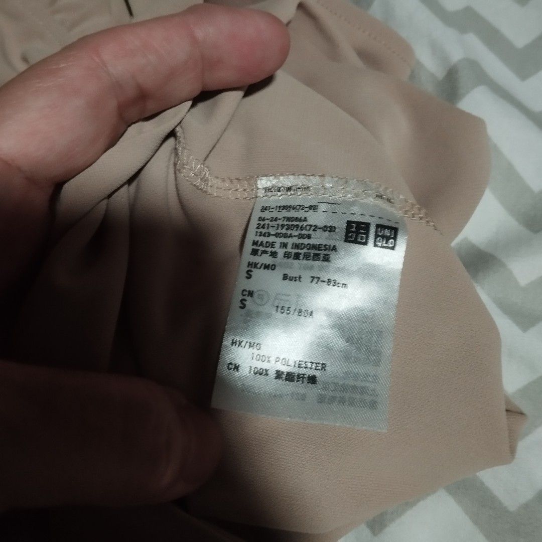 Uniqlo Pinkish Beige Polyester Blouse Size S (Category: Blouses) located in Manila. Submitted by lene48 (Listing ID 1470757901, Image 1). Description: - Brand: Uniqlo - Color: Pinkish beige - Size: S - Material: 100% polyester (lightweight and smooth drape) - Design: Crew neckline, short sleeves with gathered ruffled shoulders - Origin: Made in Indonesia - Condition: Clean inner tag with full care and sizing info attached.
