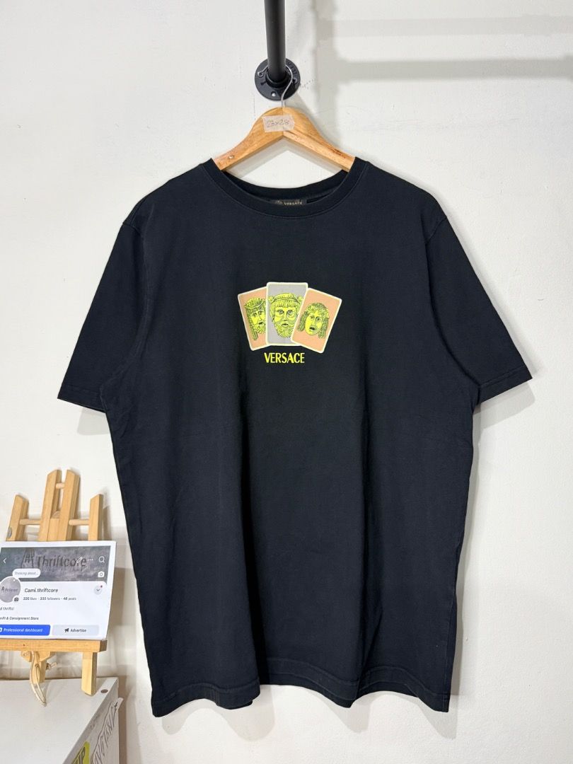 Versace Black Graphic Tee Size M (Category: Tshirts & Polo Shirts ) located in Caloocan City. Submitted by choidelfin.420 (Listing ID 1470826971, Image 1). Description: - Brand: Versace - Color: Black - Size: Medium (M) - Design: Front chest graphic with three colorful card illustrations & Greek mythology faces under the Versace logo - Material: 99% cotton, 1% polyester fiber - Fit/Style: Crew neck, short sleeve - Measurements: 23 inches pit to p