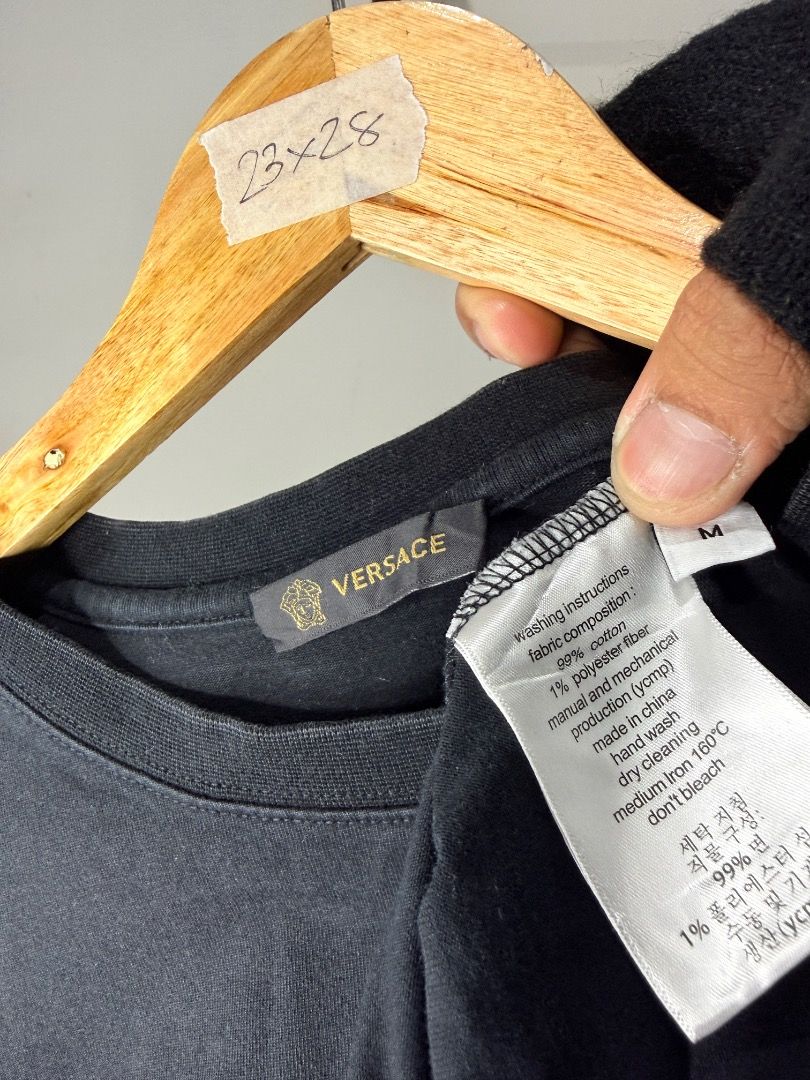 Versace Black Graphic Tee Size M (Category: Tshirts & Polo Shirts ) located in Caloocan City. Submitted by choidelfin.420 (Listing ID 1470826971, Image 2). Description: - Brand: Versace - Color: Black - Size: Medium (M) - Design: Front chest graphic with three colorful card illustrations & Greek mythology faces under the Versace logo - Material: 99% cotton, 1% polyester fiber - Fit/Style: Crew neck, short sleeve - Measurements: 23 inches pit to p