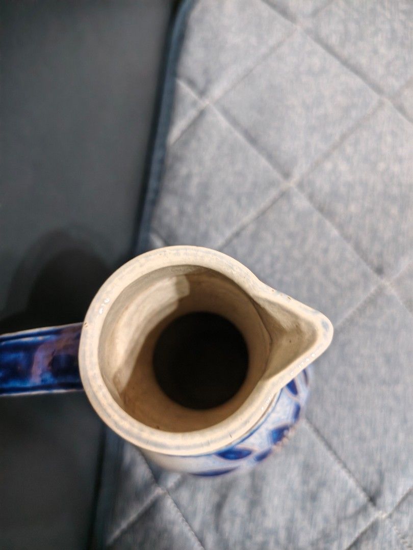 Vintage Blue and White Salt Glazed Ceramic Pitcher Jug (Category: Pitchers & Dispensers) located in Muntinlupa City. Submitted by jojiepogi123 (Listing ID 1470855801, Image 3). Description: - Handpainted blue and white floral pattern - Speckled grey-blue glaze finish - Solid and heavy stoneware construction - Features a sturdy curved handle and pouring spout - Ideal kitchen or dining table centerpiece.