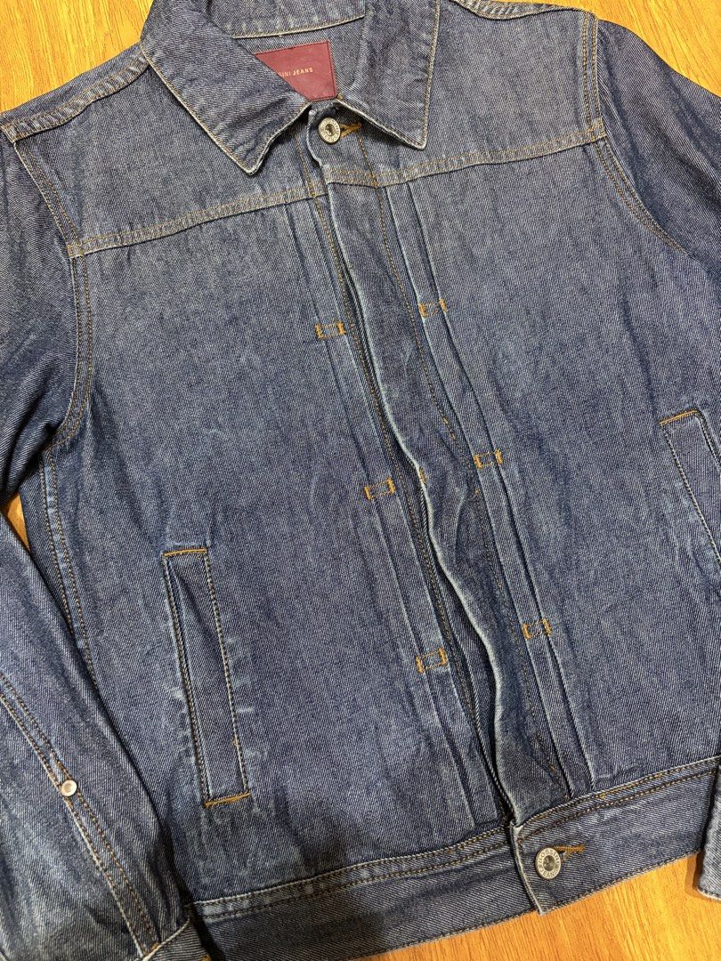 Vintage Bossini Jeans Denim Jacket (Category: Coats, Jackets and Outerwear) located in Angeles City. Submitted by lozmorlan (Listing ID 1470882877, Image 3). Description: - Brand/Item: Bossini Denim Jacket - Wash: Classic blue with contrast orange stitching - Size: 11 (Interior label) - Details: Structured front pleats, button cuffs, and branded metal buttons - Material: Sturdy, high-quality denim - Condition: Great wardrobe staple for cooler wea
