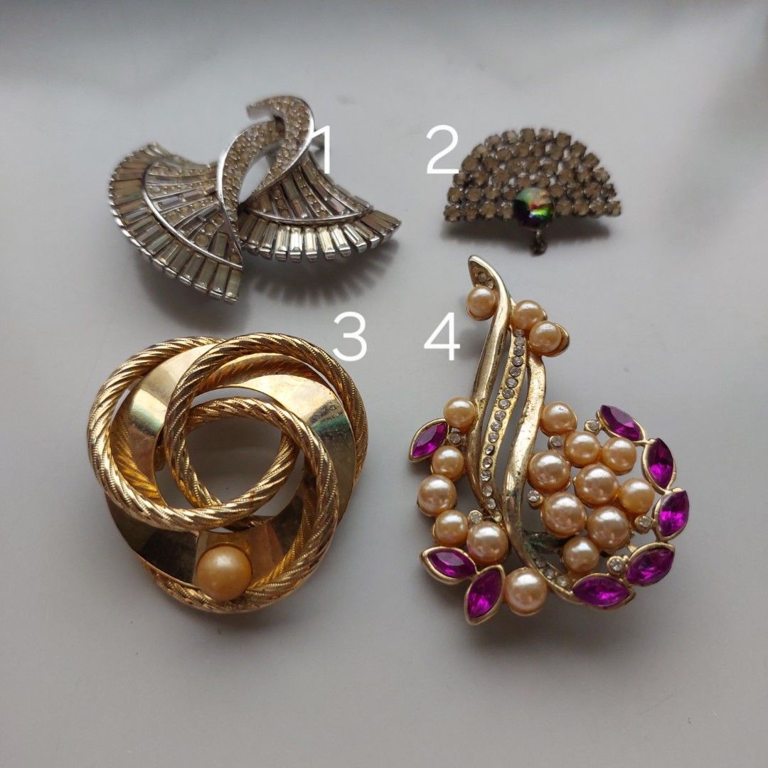 Vintage Brooch (Category: Accessory Holder, Box & Organizers) located in San Juan City. Submitted by peachykr (Listing ID 1470797737, Image 2). Description: Vintage Brooch These are vintage so there's a lot of wear and tear to them. These seem to be costume jewelry. Selling as is. Here are some flaws I noticed: 1. I see at least 2 missing gems. 2. It seems to be missing something that is supposed to be attached to it. 4. It has no needle at the b