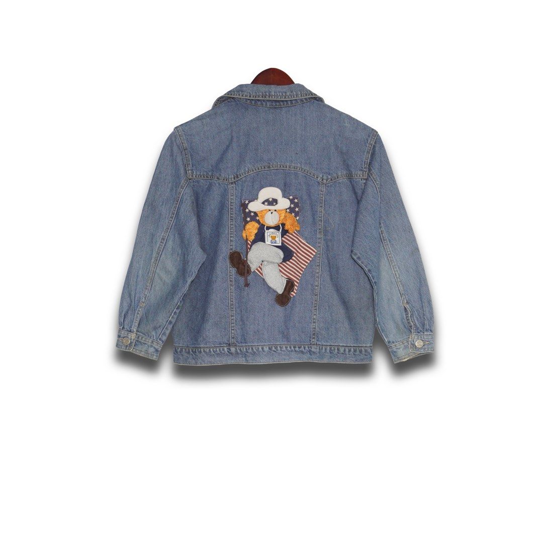 Vintage Denim Jacket (Category: Coats, Jackets and Outerwear) located in Davao. Submitted by justin_sells (Listing ID 1470828927, Image 2). Description: -Blue denim jacket - Adorable fluffy teddy bear patch on the front wearing a white hat and star shirt - Eye-catching large teddy bear patch on the back with an American flag background - Versatile casual outerwear, great for layering.