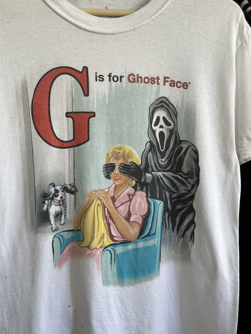 Vintage Ghost Face Graphic T-Shirt (Category: Tshirts & Polo Shirts ) located in Daet. Submitted by thrifthings2018 (Listing ID 1470844733, Image 2). Description: - Style: Vintage white graphic tee featuring 'G is for Ghost Face' - Fit & Details: Short sleeves, crew neck - Measurements: Width 19 inches, Length 28 inches - Condition: Ready to wear, with some small spots and marks near the bottom front hem.