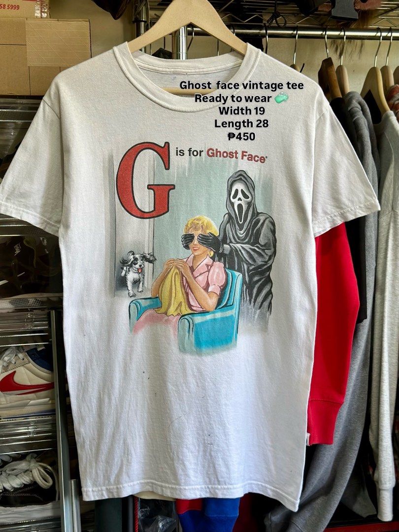 Vintage Ghost Face Graphic T-Shirt (Category: Tshirts & Polo Shirts ) located in Daet. Submitted by thrifthings2018 (Listing ID 1470844733, Image 1). Description: - Style: Vintage white graphic tee featuring 'G is for Ghost Face' - Fit & Details: Short sleeves, crew neck - Measurements: Width 19 inches, Length 28 inches - Condition: Ready to wear, with some small spots and marks near the bottom front hem.