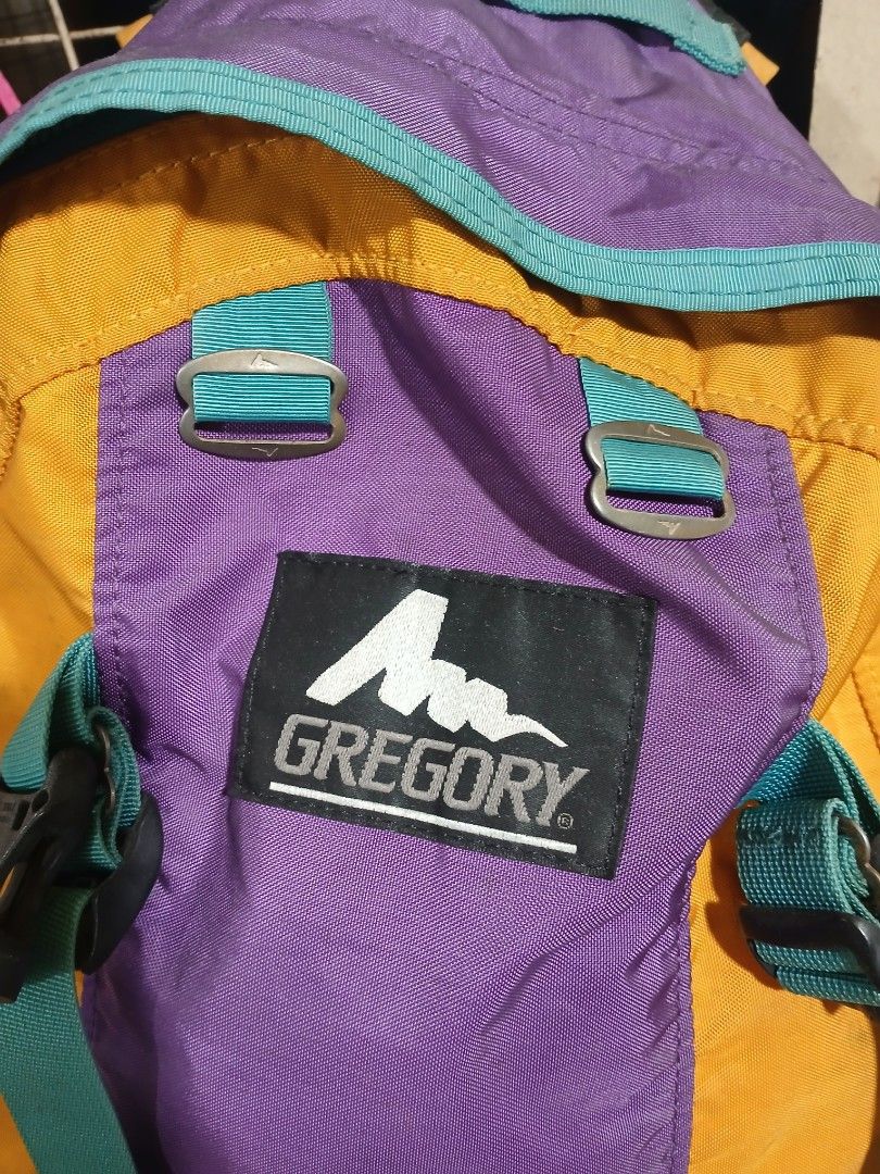 Vintage Gregory Multicolor Backpack Made in USA (Category: Backpacks) located in Manila. Submitted by zackthrift16 (Listing ID 1470887346, Image 2). Description: - Authentic vintage Gregory backpack in a vibrant yellow, purple, and teal colorway - Classic woven brand patch stitched on the front - Heavy-duty zippers with smooth metal pulls - Features the iconic American flag interior tag - Spacious main compartment with plenty of storage space - A
