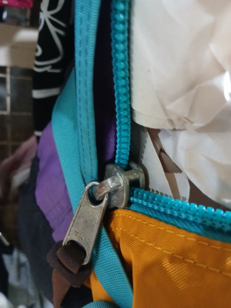 Vintage Gregory Multicolor Backpack Made in USA (Category: Backpacks) located in Manila. Submitted by zackthrift16 (Listing ID 1470887346, Image 3). Description: - Authentic vintage Gregory backpack in a vibrant yellow, purple, and teal colorway - Classic woven brand patch stitched on the front - Heavy-duty zippers with smooth metal pulls - Features the iconic American flag interior tag - Spacious main compartment with plenty of storage space - A