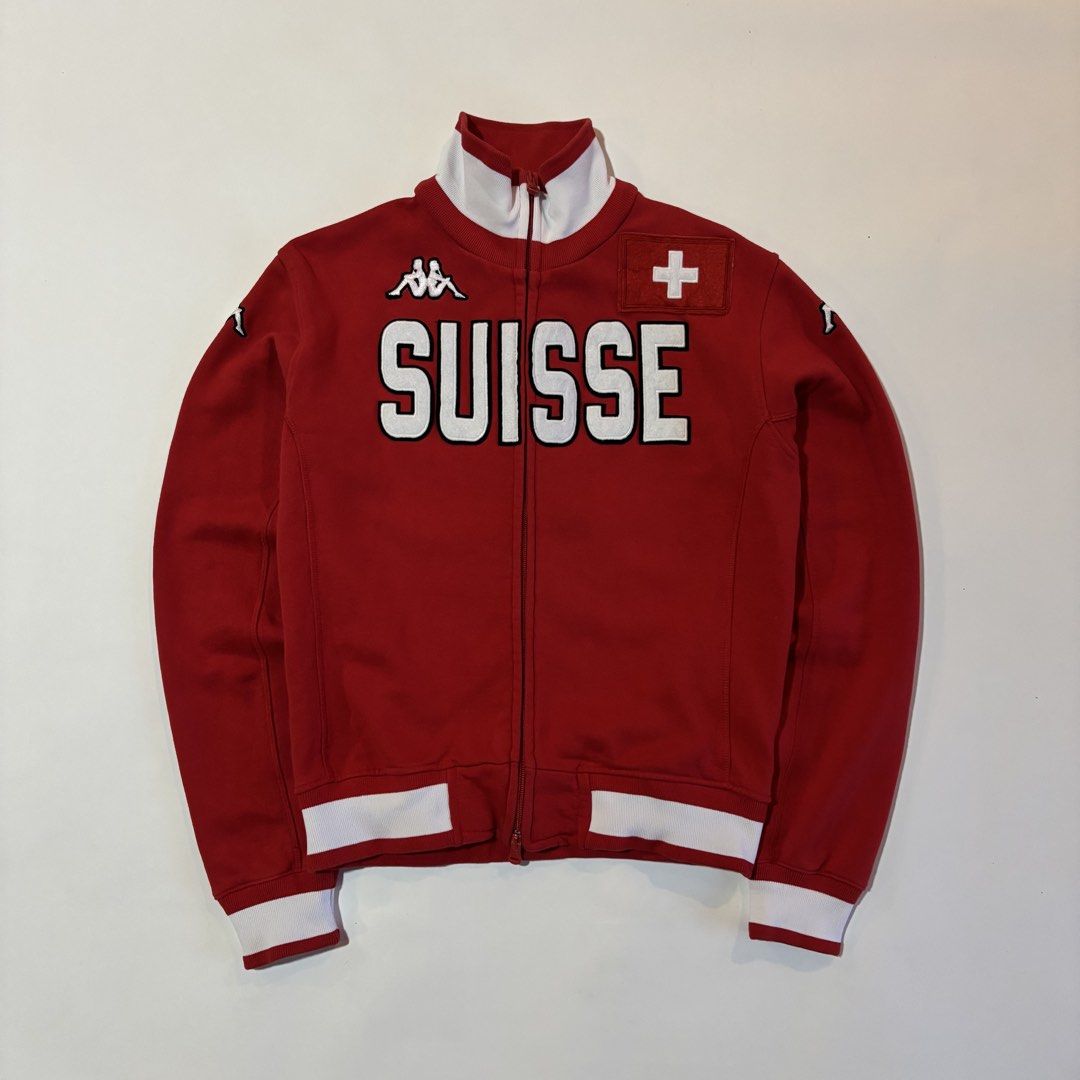 Vintage Kappa Suisse Red Track Jacket Medium (Category: Coats, Jackets and Outerwear) located in Dipolog. Submitted by dionato (Listing ID 1470777617, Image 1). Description: - Brand: Kappa - Style: Red track jacket with white ribbed collar, cuffs, and hem - Design: Large embroidered 'SUISSE' across the chest with classic Kappa logo and stitched Swiss flag patch - Hardware: Full zip front with dual pullers - Size: Medium - Material: Heavy cotton b
