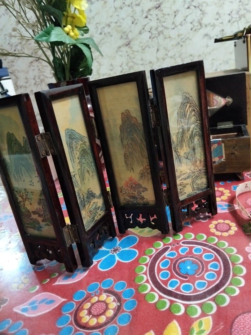 Vintage Mini Four-Panel Wooden Table Screen Asian Art (Category: Vintage Collectibles) located in Abucay. Submitted by cristineca20489 (Listing ID 1470916146, Image 2). Description: - Type: Miniature four-panel tabletop room divider - Material: Dark wood frames with durable metal hinges - Design: Reversible; one side features painted birds on floral branches, reverse side shows a traditional mountain landscape - Features: Fully foldable for easy 