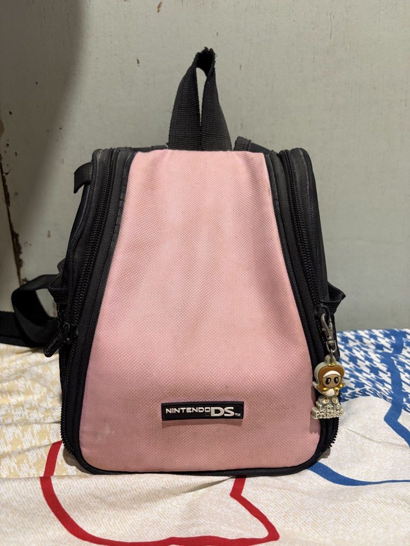 Vintage Nintendo DS Backpack / Carrying Bag (Category: Nintendo) located in Bacoor. Submitted by michtbrnilla (Listing ID 1470761937, Image 1). Description: Cute pink and black Nintendo DS bag 🩷🖤 * Unique pink and black design * Spacious interior with compartments * Multiple zippered pockets * Padded interior for storage and protection * Can be used for gaming accessories or everyday essentials 📌 Condition: Pre-loved 📌 Price: ₱800 (negotiable