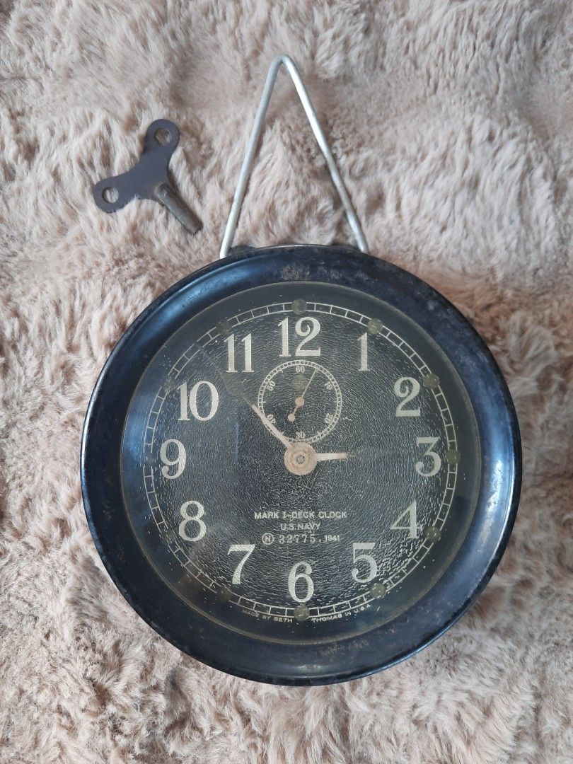 Vintage Seth Thomas U.S. Navy Mark I Deck Clock 1941 (Category: Vintage Collectibles) located in Marilao. Submitted by mariealeiah (Listing ID 1470748612, Image 1). Description: - Authentic 1941 U.S. Navy Mark I deck clock by Seth Thomas - Serial Number: 32775 - Design: Classic black round casing with white numbering and top sub-dial - Condition: Shows authentic age-related wear and crazing on the dial face - Inclusions: Original winding key and 