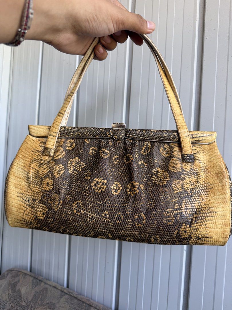 Vintage Snakeskin leather Handbag (Category: Shoulder Bags) located in Digos. Submitted by old_soul. (Listing ID 1470802266, Image 2). Description: - Authentic vintage handbag covered in genuine snakeskin leather - Striking dark brown and yellow natural pattern - Secure top metal frame clasp closure - Matching dual top handles for easy carrying - Structured rectangular shape with a rounded bottom gusset - Impeccable, clean stitching along all edg
