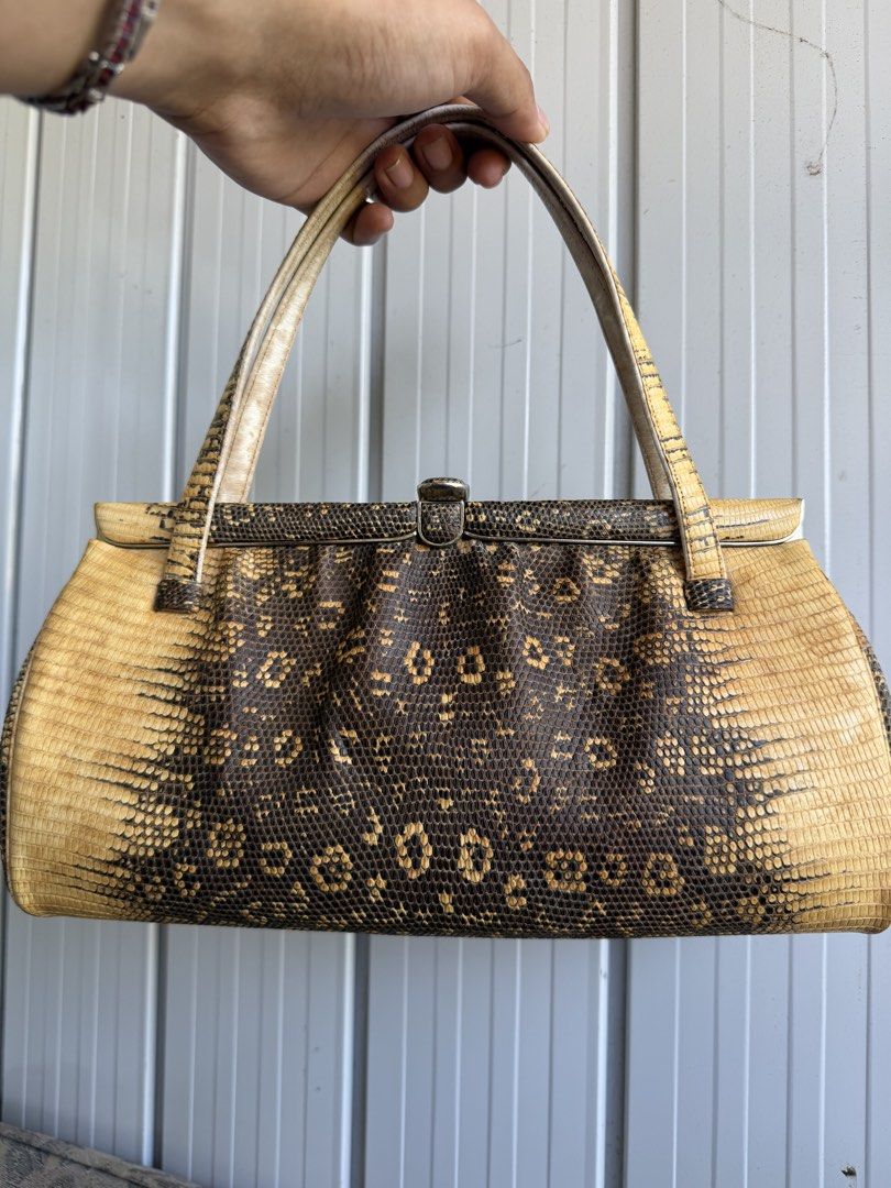 Vintage Snakeskin leather Handbag (Category: Shoulder Bags) located in Digos. Submitted by old_soul. (Listing ID 1470802266, Image 1). Description: - Authentic vintage handbag covered in genuine snakeskin leather - Striking dark brown and yellow natural pattern - Secure top metal frame clasp closure - Matching dual top handles for easy carrying - Structured rectangular shape with a rounded bottom gusset - Impeccable, clean stitching along all edg