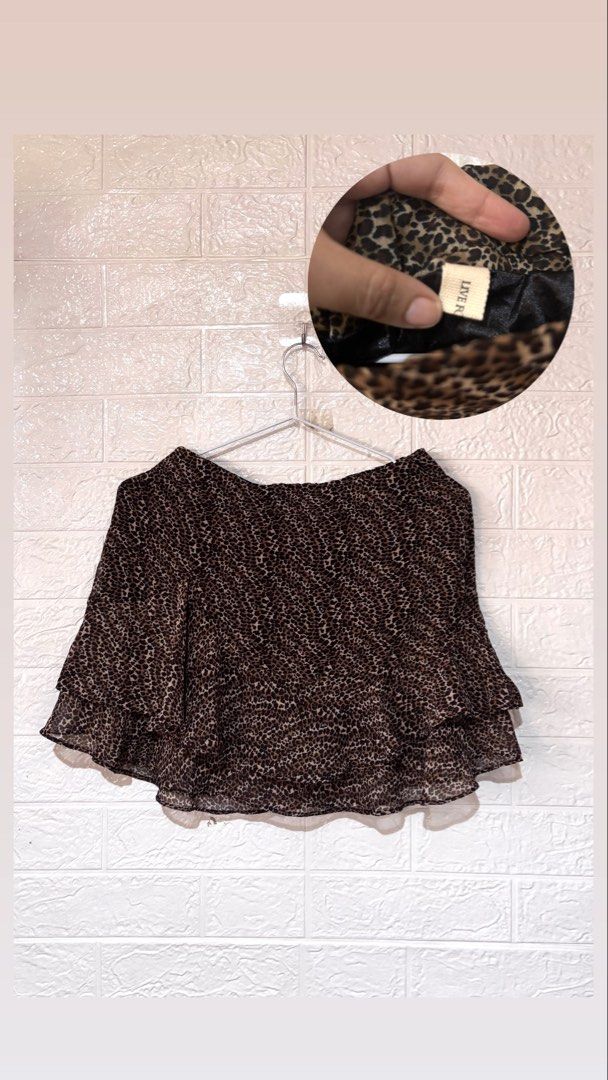 Vintage Y2k whimsy goth Leopard skirt (Category: Skirts) located in Cebu City. Submitted by airahxoxo (Listing ID 1470746652, Image 1). Description: - Trendy leopard print mini skirt in neutral brown and black - Lightweight chiffon-like fabric with full black lining for comfort - Flattering short flared silhouette with a tiered ruffle hem - Easy slip-on style featuring a stretchy elastic waistband - Size tag: Live - Condition: Worn a couple of ti