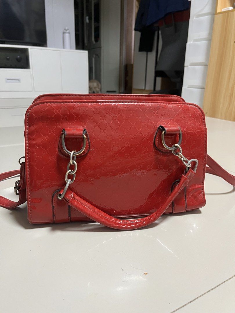 Vintage-Style Red Glossy Handbag with Strap (Category: Luxury Bags & Wallets) located in General Trias. Submitted by walterwhiteyo (Listing ID 1470756881, Image 3). Description: Vibrant Glossy Red Condition: Preloved / Good condition (see photo for details) Features: Glossy patent finish with a subtle debossed pattern Sturdy top handles plus an adjustable/detachable shoulder strap Roomy enough for your daily essentials (phone, wallet, keys, makeu