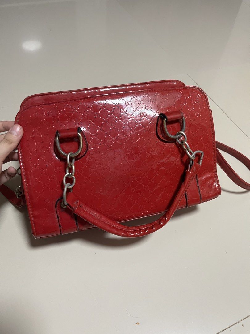 Vintage-Style Red Glossy Handbag with Strap (Category: Luxury Bags & Wallets) located in General Trias. Submitted by walterwhiteyo (Listing ID 1470756881, Image 2). Description: Vibrant Glossy Red Condition: Preloved / Good condition (see photo for details) Features: Glossy patent finish with a subtle debossed pattern Sturdy top handles plus an adjustable/detachable shoulder strap Roomy enough for your daily essentials (phone, wallet, keys, makeu