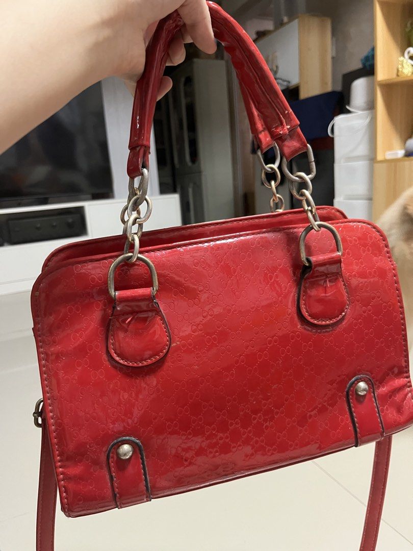 Vintage-Style Red Glossy Handbag with Strap (Category: Luxury Bags & Wallets) located in General Trias. Submitted by walterwhiteyo (Listing ID 1470756881, Image 1). Description: Vibrant Glossy Red Condition: Preloved / Good condition (see photo for details) Features: Glossy patent finish with a subtle debossed pattern Sturdy top handles plus an adjustable/detachable shoulder strap Roomy enough for your daily essentials (phone, wallet, keys, makeu