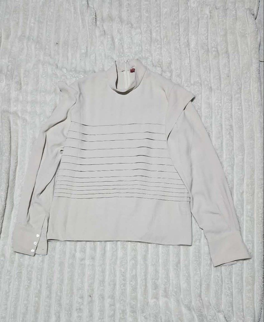 Vivienne Tam Long Sleeves Top (Category: Longsleeves) located in Caloocan City. Submitted by bea_d_ (Listing ID 1470768890, Image 1). Description: VIVIENNE TAM High-Neck Long Sleeve Blouse Elegant designer top featuring subtle horizontal pin-tuck / pleated front panel detailing, a chic mock high-neck collar with a back zipper closure, and structured shoulder accents. Perfect for office wear, formal occasions, or elevated casual styling. • Brand: 