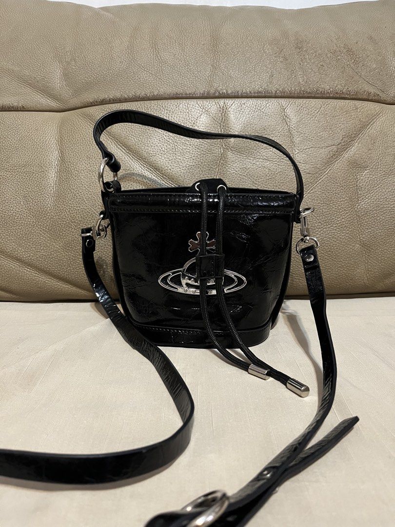 Vivienne Westwood Bucket Bag (Category: Luxury Bags & Wallets) located in Calamba. Submitted by jupreloved_ (Listing ID 1470793057, Image 2). Description: Features shiny silver hardware, iconic large metal orb logo, secure drawstring fabric interior, short handle, and long adjustable strap. Brand: Vivien Westwood Size: Small Shipping through J&T. Payment are strictly through GCASH only, no COD. Exact size and color may be different from the pictu