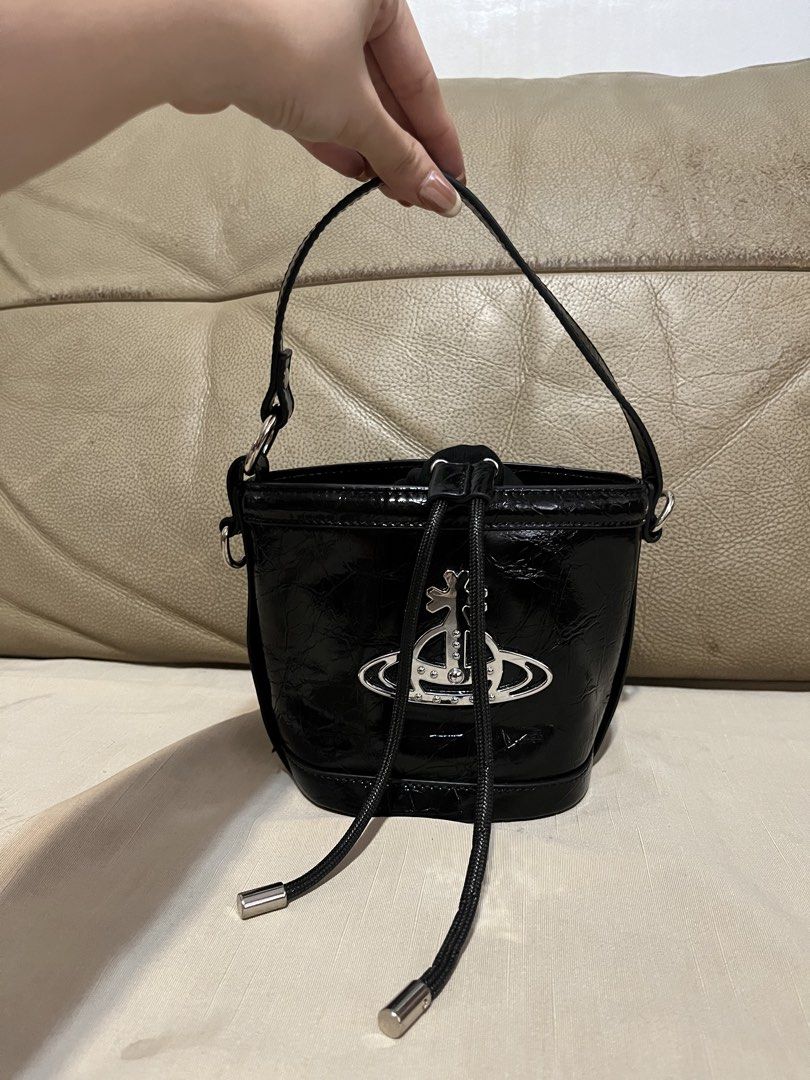 Vivienne Westwood Bucket Bag (Category: Luxury Bags & Wallets) located in Calamba. Submitted by jupreloved_ (Listing ID 1470793057, Image 1). Description: Features shiny silver hardware, iconic large metal orb logo, secure drawstring fabric interior, short handle, and long adjustable strap. Brand: Vivien Westwood Size: Small Shipping through J&T. Payment are strictly through GCASH only, no COD. Exact size and color may be different from the pictu