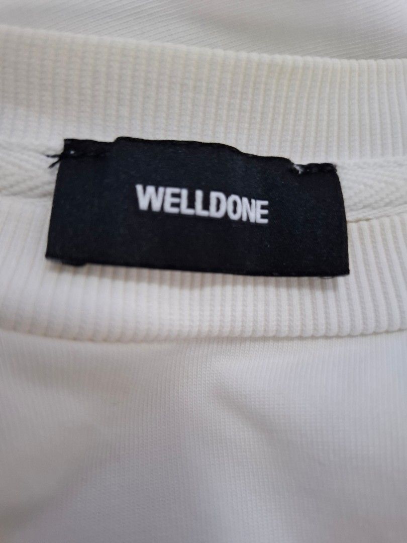 We11done White Repeated Logo T-Shirt (Category: Tshirts & Polo Shirts ) located in Manila. Submitted by jazil.ladyliz (Listing ID 1470764721, Image 3). Description: - Brand: We11done - Color: Clean White - dimes 25x31 - Design: Bold repeated black logo print on front, rubberized 'WE11DONE ESTABLISHED 2015' patch at lower back - Material: Premium heavy cotton for durability and comfort - Fit: Relaxed, streetwear fit - Details: Includes inner woven
