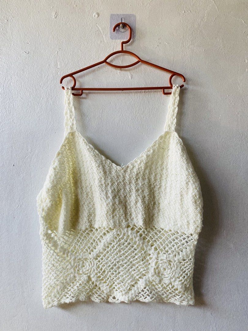 White Crochet Knit Crop Top (Category: Sleeveless) located in Caloocan City. Submitted by lovemyclothes21 (Listing ID 1470756335, Image 1). Description: - Color: White - Style: Crochet knit crop top with spaghetti straps and V-neck - Details: Openwork mesh pattern with floral woven hem - Fabric: Lightweight and stretchy, ideal for warm weather or layering - Condition: Brand new / Excellent.