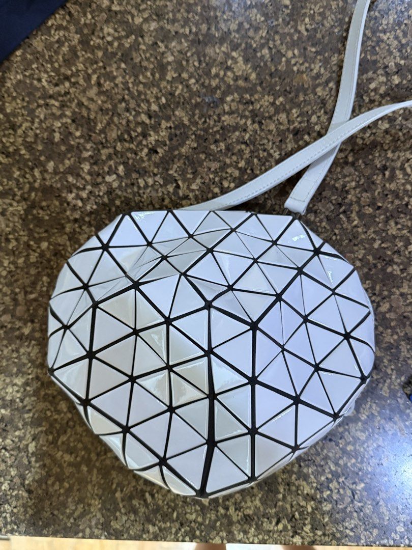 White Geometric Triangle Lattice Crossbody Shoulder Bag (Category: Luxury Bags & Wallets) located in Manila. Submitted by riccalinds06364 (Listing ID 1470849036, Image 2). Description: - Stylish white crossbody bag with eye-catching geometric triangle panels - Features sleek black trim and a glossy, flexible lattice structure - Secure top zipper closure to keep your belongings safe - Includes an adjustable white shoulder strap for comfortable wea