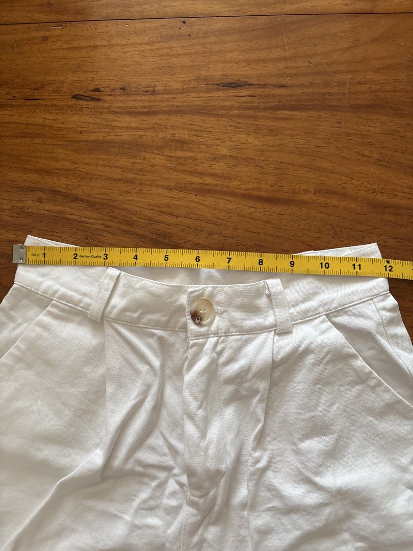 White high waisted pleated shorts (Category: Shorts) located in Manila. Submitted by damburgurt (Listing ID 1470800504, Image 2). Description: - Style: High-waisted white denim shorts with a trendy pleated front - Closure: Tortoiseshell button - Features: Front slash pockets and belt loops - Size: Flat lay waist measures roughly 12 inches across - Condition/Look: Crisp fabric, clean and versatile - Pairing: Perfect with basic tees or blouses for 