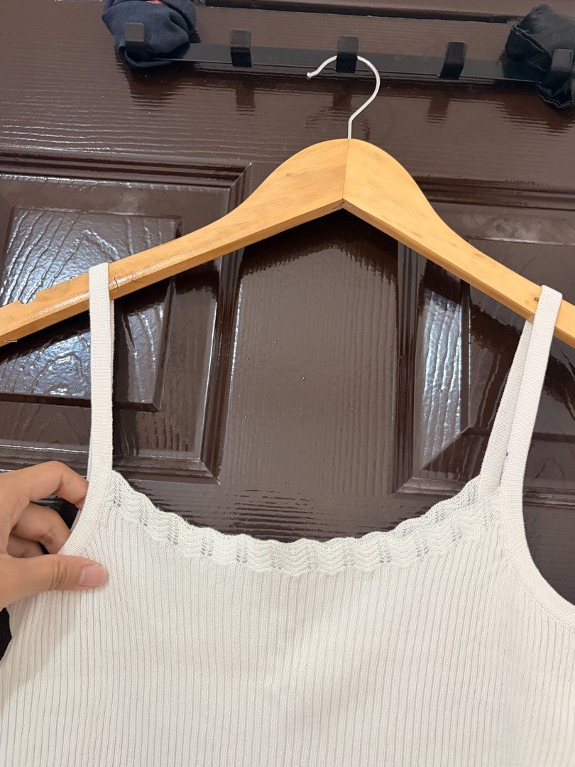 White ribbed tank top with scalloped hem (Category: Sleeveless) located in Marikina City. Submitted by _bananahanaa (Listing ID 1470801957, Image 2). Description: - Color: White - Material: Stretchy ribbed knit - Design: Square neckline with thin straps - Details: Scalloped lace trimming on neckline and bottom hem - Fit: True to size, super comfortable for daily wear - Styling: Great basic piece to match with jeans or skirts stretchy, can fit sma