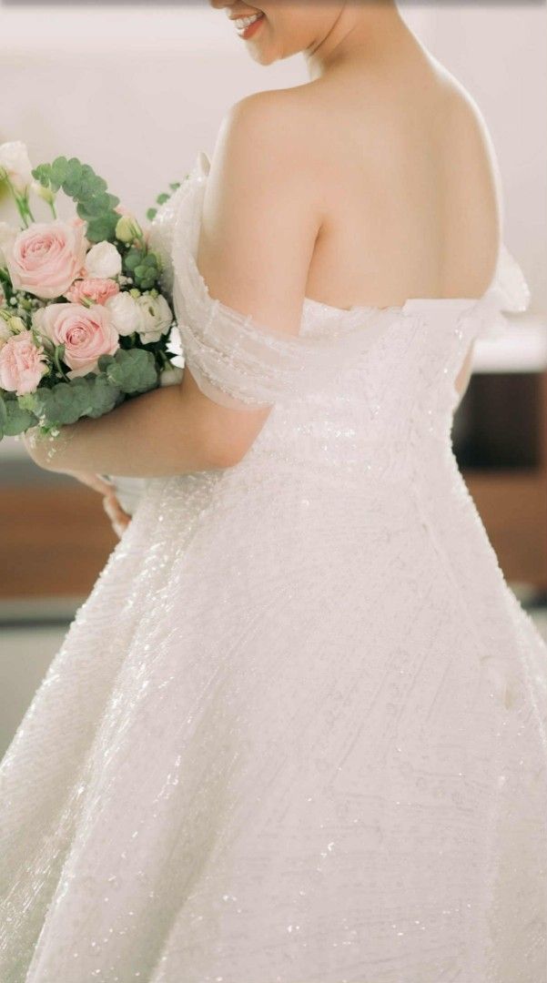 WHITE WEDDING GOWN (Category: Evening dresses & gowns) located in Bulacan. Submitted by Domozz (Listing ID 1470780759, Image 1). Description: - Color: White - Style: Strapless ball gown with straight neckline and fitted bodice - Back: Adjustable corset back for a custom fit - Details: Heavy sparkle embellishments from top to bottom that catch the light - Feature: Long, dramatic train for a grand entrance.