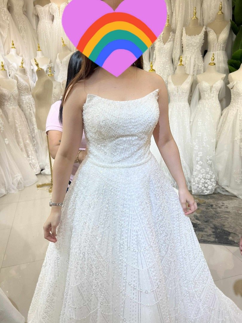 WHITE WEDDING GOWN (Category: Evening dresses & gowns) located in Bulacan. Submitted by Domozz (Listing ID 1470780759, Image 3). Description: - Color: White - Style: Strapless ball gown with straight neckline and fitted bodice - Back: Adjustable corset back for a custom fit - Details: Heavy sparkle embellishments from top to bottom that catch the light - Feature: Long, dramatic train for a grand entrance.