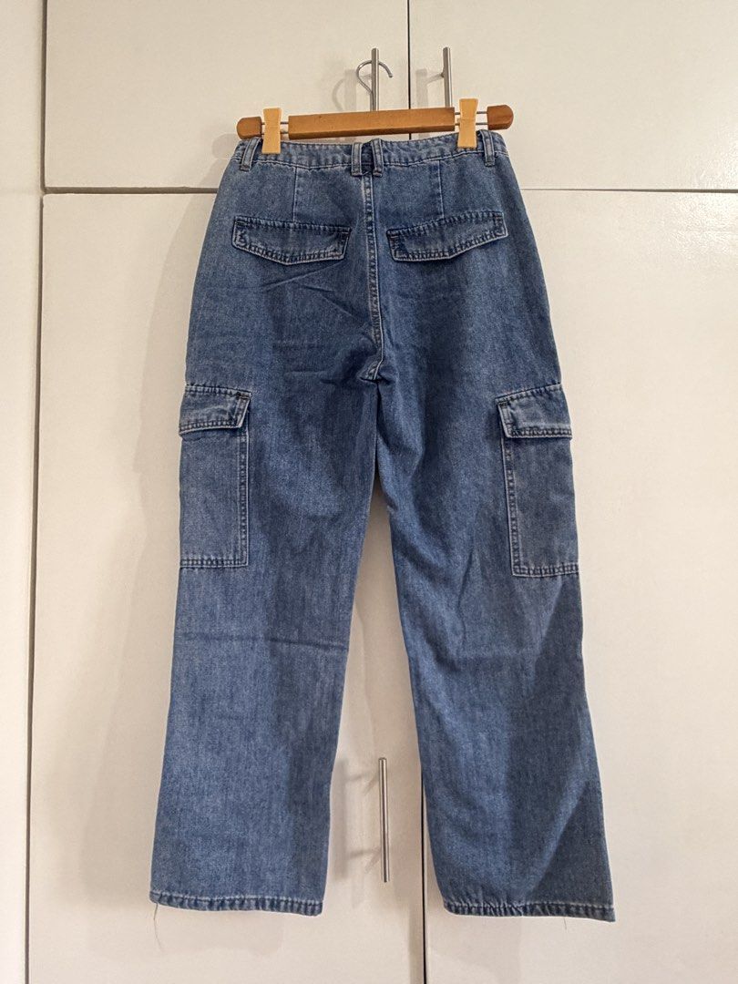 Woman Denim Cargo Jeans Size S (Category: Jeans) located in Marikina City. Submitted by _bananahanaa (Listing ID 1470801538, Image 2). Description: - Brand: Woman Denim - Size: Small - Fit: High-waisted with a straight leg cut - Color/Wash: Classic medium wash - Details: Multiple utility pockets on sides and back - Closure: Button and zipper fly size 28.