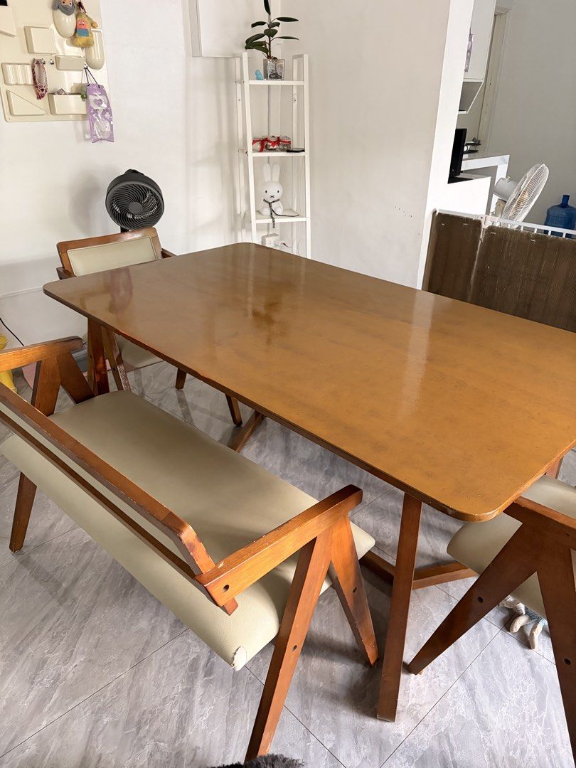 Wooden dining table with bench and chairs (Category: Tables & Sets) located in Taguig. Submitted by jesrm (Listing ID 1470821459, Image 2). Description: - Complete dining set in a stylish medium brown wood finish - Includes one long bench with backrest, one separate long bench, and two matching armchairs - Comfortable cream-colored faux leather upholstery on the armchairs - Sturdy and durable wooden frames built to last .