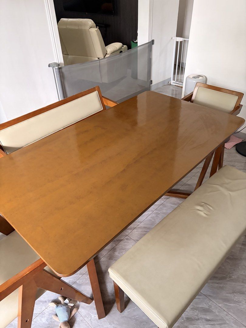 Wooden dining table with bench and chairs (Category: Tables & Sets) located in Taguig. Submitted by jesrm (Listing ID 1470821459, Image 3). Description: - Complete dining set in a stylish medium brown wood finish - Includes one long bench with backrest, one separate long bench, and two matching armchairs - Comfortable cream-colored faux leather upholstery on the armchairs - Sturdy and durable wooden frames built to last .